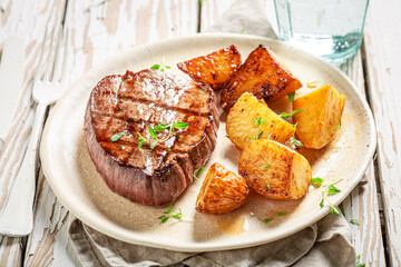 Tasty steak roasted with potatoes and herbs