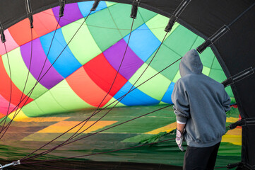 Inside of colorful hot air balloon. Person preparing balloon to rise in sky for adventure