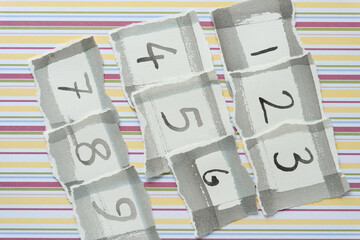 paper tiles with numbers on decorative scrapbook paper with stripes