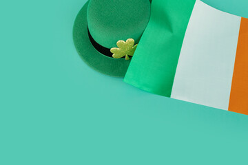 green irish leprechaun hat with gold clover and irish flag on green background, saint patrick day...