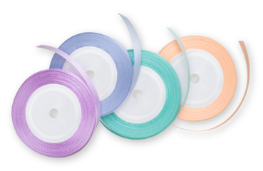 Rolls of satin ribbons for decorations and make shiny bows, embellished wrap package for festive, Easter, Christmas, wedding and birthday gift box. Isolated on white background