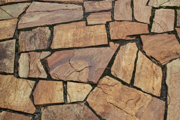 Cobble marble stone paving mosaic texture background. Natural brown slate granite slab mountain...
