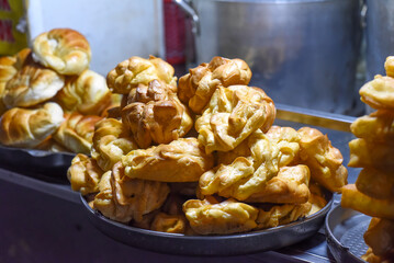 eclair pastries with custard cream in night market of street food in Da Lat in Vietnam