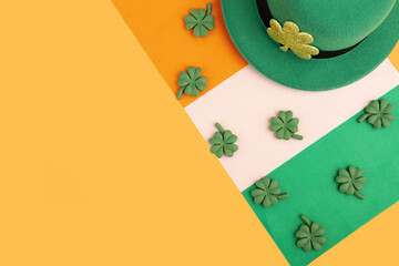green irish leprechaun hat with shamrocks and irish flag on orange background, saint patrick day...