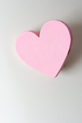 pink wooden heart object on a paper background