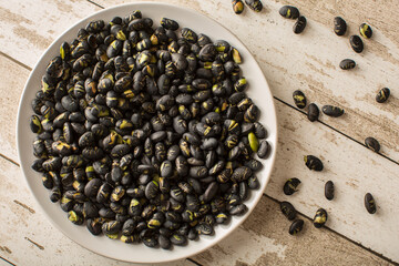 Ready to eat crunchy black beans on the white plate
