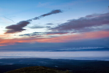 mountain peaks visible through the clouds
