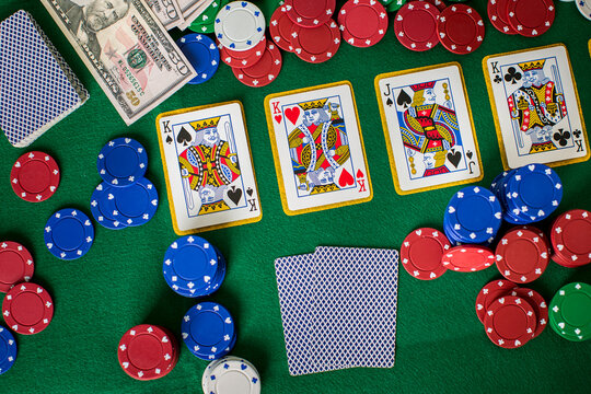 Poker concept with cards, money and gambling chips on green table	