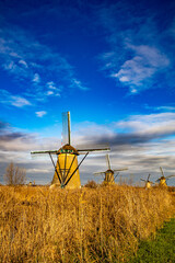 breathtaking beautiful inspirational landscape with windmills in Kinderdijk, Netherlands at sunset. Fascinating places, tourist attraction. © Marcin