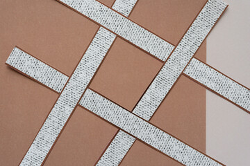 overlapping paper stripes with knit pattern on brown and blank paper