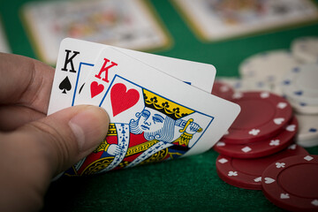 Closeup of hands with kings, Texas Hold'em Poker gambling concept - obrazy, fototapety, plakaty