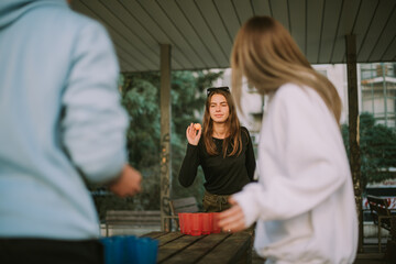 Group of friends playing beer pong