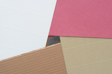 corrugated white and beige paper and rough red and cardboard object background