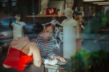 Fototapeta premium Tattoo artist looking at the client