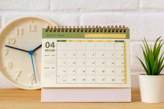 Hello April.Desktop calendar for April 2023 on the table.