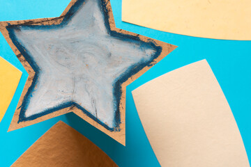 textured star and paper cards on blue - macro lens, particular focus