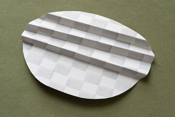 folded paper shape decorated with ink stamp marks