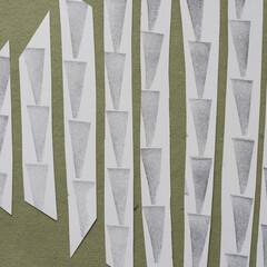 paper stripes with ink stamped arrow shapes pointing down