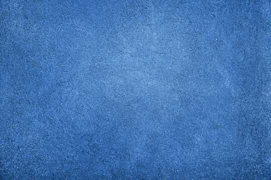 Blue abstract texture background with space for design. Painted rough concrete wall surface. Close-up. Empty.