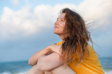 Naklejka premium Portrait of happy girl, young carefree woman enjoying summer vacation on sea, walking on beach sand, smiling and having fun in tropical country, relaxing on nature. Summertime, happiness concept.