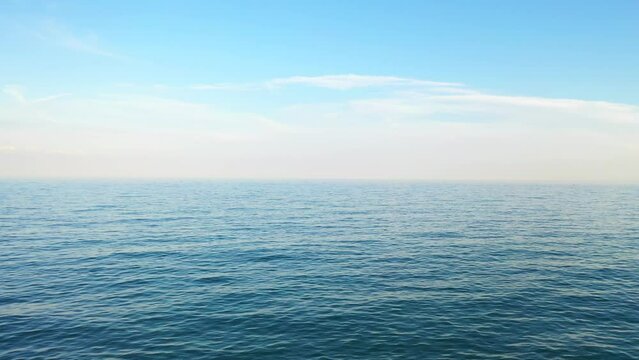 Seascape background with sea horizon and clear deep blue sky