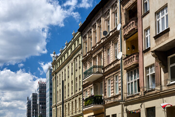 Fototapeta na wymiar facades of historic tenement houses and modern office buildings in the city of Poznan