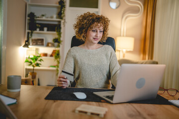 One woman caucasian female shopping online use laptop and card happy