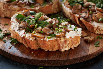 Close-up of appetizing bruschetta cream cheese and fried champignon mushrooms.