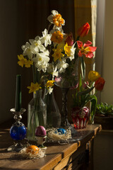 still life with flowers, easter eggs and candle