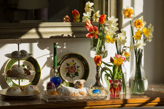 still life with flowers, easter eggs, lamb and candle