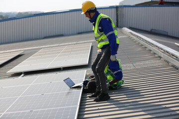 technician in work gloves installing stand-alone photovoltaic solar panel system under beautiful blue sky with clouds. Concept of alternative energy and power sustainable resources. 