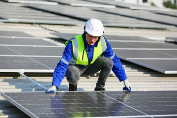Engineer service check installation solar cell on the roof of factory on the morning.