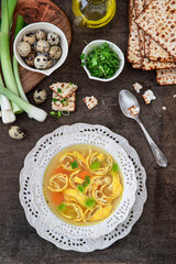 Vegetable broth with egg pancakes and matzo bread. Pesah celebration concept (jewish Passover holiday).	