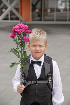 The first day of school, a bouquet of flowers for the first teacher and warm autumn