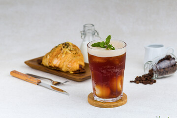 Iced black tea with lychee on wood coaster and white background - Powered by Adobe