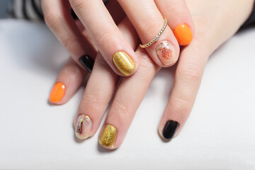 Nail art and design. Female hands with oriental-style nails design with tiger stripes
