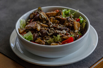The meat salad in a plate is on the table for advertising