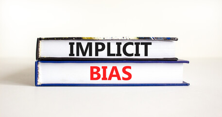 Implicit bias symbol. Concept words Implicit bias on books. Beautiful white table white background. Business psychology implicit bias concept. Copy space.