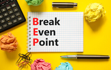 BEP break even point symbol. Concept words BEP break even point on white note on a beautiful yellow...