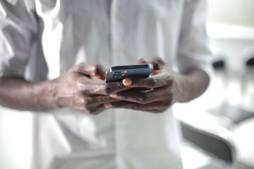 Black businessman enters data into the phone