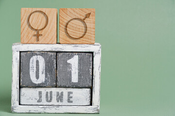 June 1 on wooden calendar and symbols of man and woman.Concept for Parents Day.
