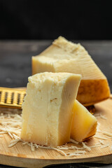 gruyere hard yellow cheese. a traditional Swiss hard yellow cheese without holes, with a dark crust and a pleasant floral and nutty aroma, place for text, top view