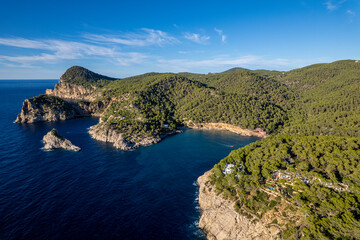 Aerial photographs of the beaches of Cala Salada y Cala Saladeta ,on the island of Ibiza during a sunny summer day with blue sky and turquoise water