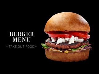 Veggie burger with meat-free cutlet, Feta cheese, tomatoes, lettuce, bbq sauce. burger isolated on black background. Ready menu sandwich advertising banner with text and copy space