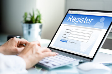 Businesswoman's Hand Filing Online Registration Form