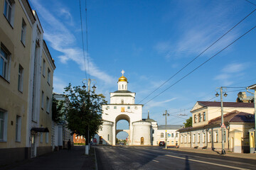VLADIMIR, Russia - AUGUST, 18, 2022: white stone golden gate with a shiny dome in the old town on a...