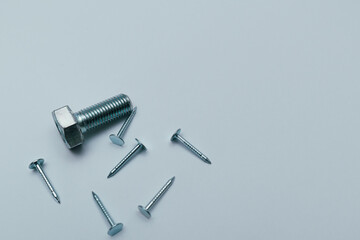 Set of bolts, screws, nails on a white background. Construction abstraction. Industrial background....