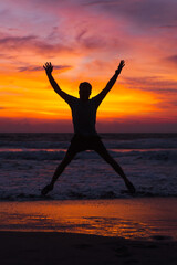 Man at sunset, a brightly colored sunset in Bali.