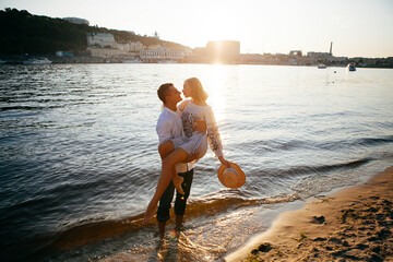 Young couple at sunset by the water