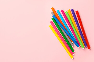 Fototapeta premium Many bright markers on pink background, flat lay. Space for text